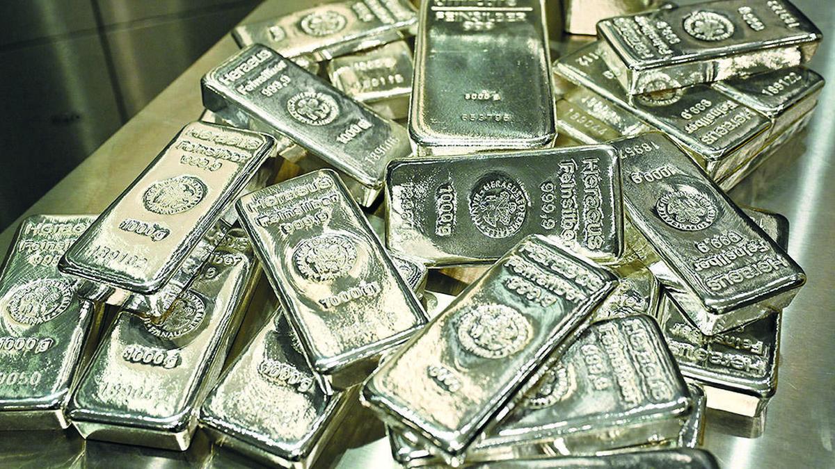 Silver prices rising faster than gold shown with silver and gold bars on an upward market chart, highlighting the surge in silver compared to gold.